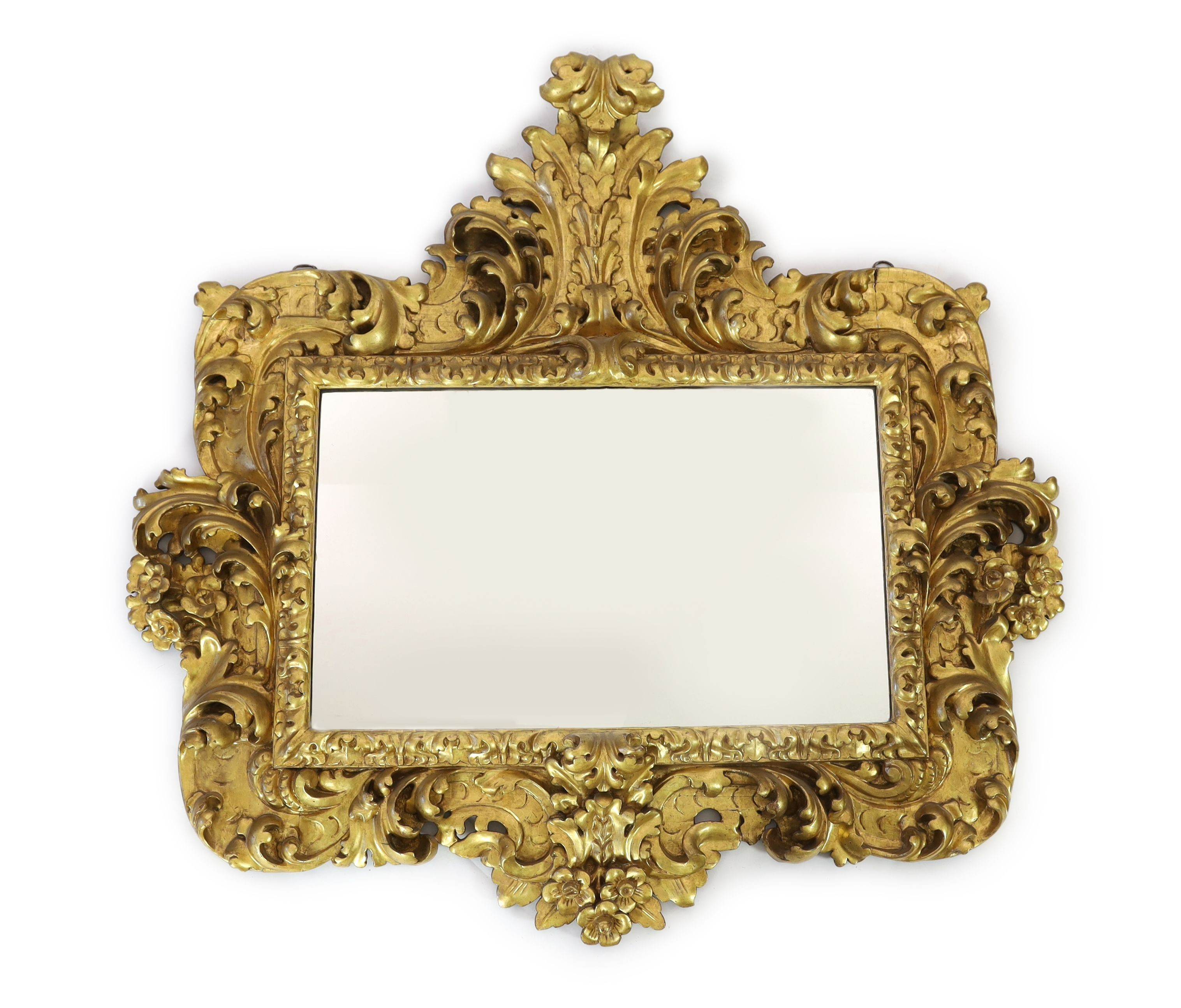 A mid 19th century Florentine ornately carved giltwood wall mirror, W.166cm H.158cm